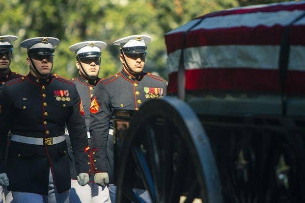 <em>Marine Corps Body Bearers escort the casket of Sgt. Nicole Gee during her funeral at Arlington National Cemetery (U.S. Marine Corps)</em>