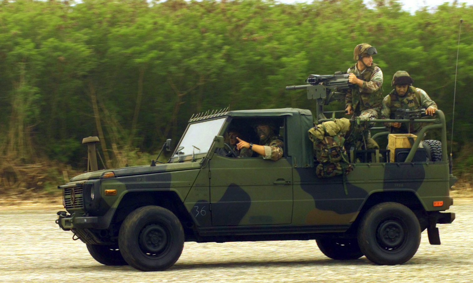 Marines from Weapons Company (WC), 2nd Battalion, 4th Marine Regiment race their Interim Fast Attack Vehicle (IFAV) along the North Field, on Tinian Island, in support of Exercise TANDEM THRUST 2003.