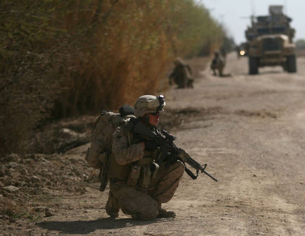Seaman Casey McLaughlin, a corpsman with India Company, 3rd Battalion, 6th Marine Regiment, provides security during a patrol in Marjah, Helmand province, Afghanistan, Feb. 24, 2010. Marines and Afghan National Army soldiers patrolled through a residential area of the area to conduct counterinsurgency operations as part of Operation Moshtarak, a push to rid Marjah of Taliban presence and intimidation. (USMC photo by Lance Cpl. Tommy Bellegarde)