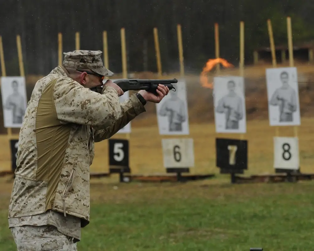 <em>An Embassy Security Marine qualifies with a Remington 870 shotgun (U.S. Marine Corps)</em>