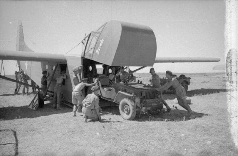 Preparing for the July 1943 <a href="https://en.wikipedia.org/wiki/Allied_invasion_of_Sicily">Sicily campaign</a>: a jeep is loaded onto an American <a href="https://en.wikipedia.org/wiki/Waco_CG-4">Waco CG-4</a>A glider plane.