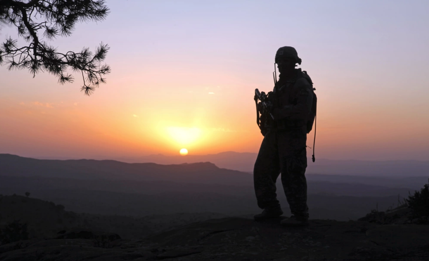 A soldier patrols during sunset, in the mountains of Afghanistan. U.S. Army photo. 