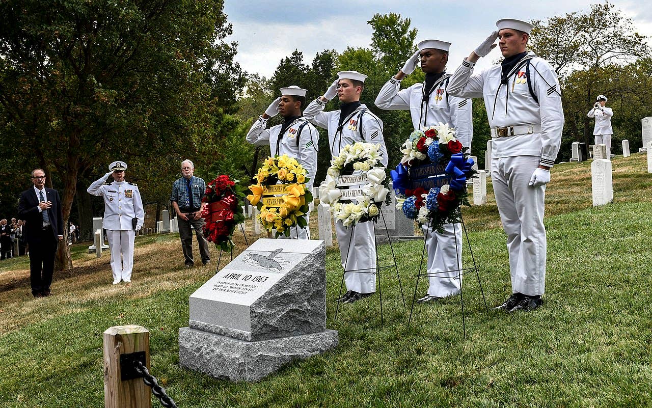 ARLINGTON, Virginia (September 26, 2019) Sailors, currently assigned to the Ceremonial Guard, salute as Taps is played during a wreath laying ceremony placed at USS Thresher (SSN 593) Commemorative Monument in Arlington National Cemetery. (U.S. Navy photo by Mass Communication Specialist 2nd Class (SW/AW) Mutis A. Capizzi/RELEASED)