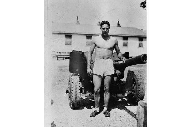 <em>Dole poses with an artillery piece in 1943 (U.S. Army)</em>