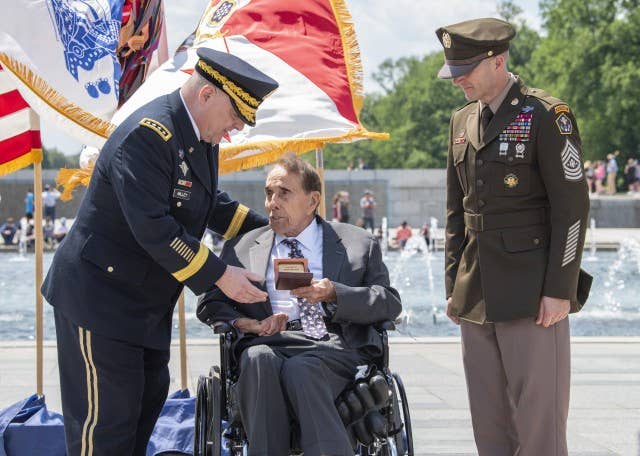 <em>Army Chief of Staff Gen. Mark A. Milley (left) and Sgt. Maj. of the Army Daniel A. Daley (right) present Dole with his colonel rank insignia during an honorary promotion ceremony at the National WWII Memorial (U.S. Army)</em>