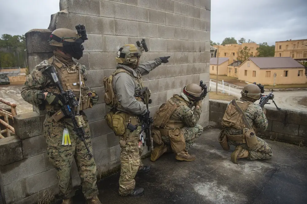 <em>2/6 Marines and a Green Beret (second from the left) conduct a joint training exercise. Note the Glock 19 in the Green Beret's holster (U.S. Marine Corps)</em>