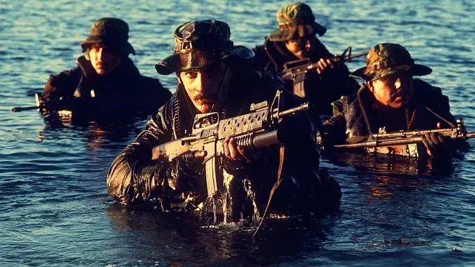 <em>Navy SEALs emerge from the water c. 1986 (U.S. Navy)</em>