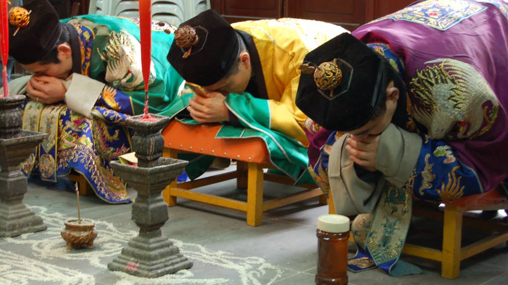Priests of the Zhengyi order bowing while officiating a rite at the White Cloud Temple of Shanghai. (Wikipedia)