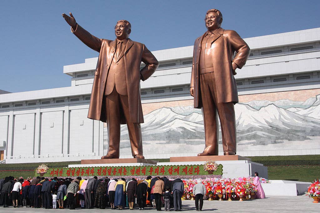 North Korean citizens paying respect to the statues of Kim Il-sung (left) and Kim Jong-il at the Mansudae Grand Monument.