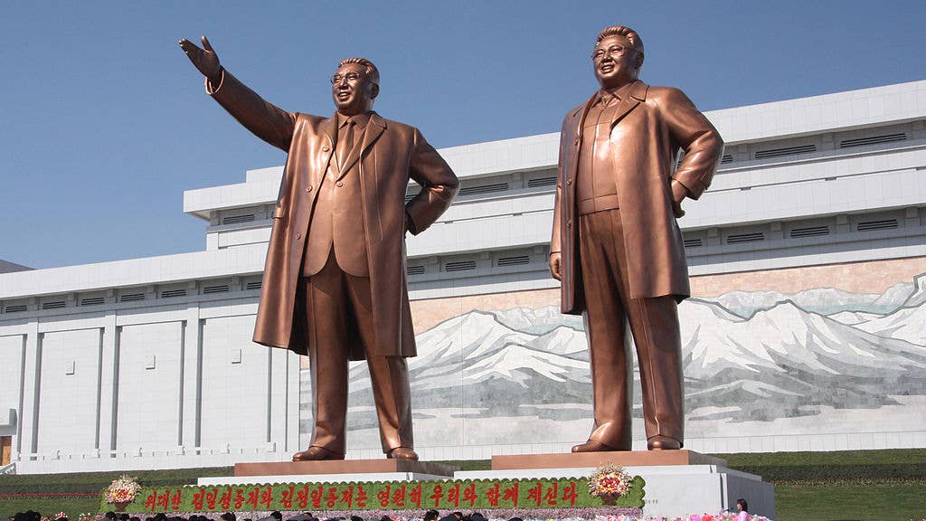 North Korean citizens paying respect to the statues of Kim Il-sung (left) and Kim Jong-il at the Mansudae Grand Monument.
