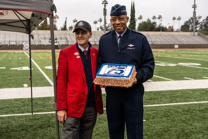 <em>Tournament of Roses President Bob Miller and Air Force Chief of Staff Gen. CQ Brown, Jr., present a cake in honor of the Air Force’s upcoming 75th birthday (U.S. Air Force)</em>