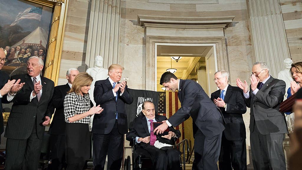 President Donald J. Trump participates in the Congressional Gold Medal Ceremony Honoring Senator Bob Dole Wednesday January 17, 2018, at the U.S. Capitol in Washington, D.C.  Also shown is Vice President Mike Pence. (Official White House Photo by Shealah Craighead)