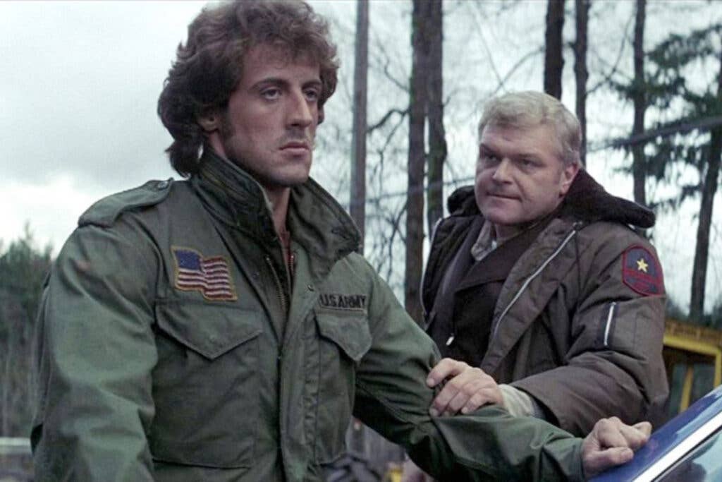 Stallone (right) as Rambo with Dennehy (left) as Teasle in <em>First Blood</em>. Photo courtesy of Yahoo.com.