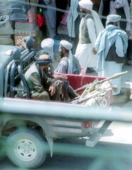 Taliban police patrolling the streets of <a href="https://en.wikipedia.org/wiki/Herat">Herat</a> in a pick-up truck.