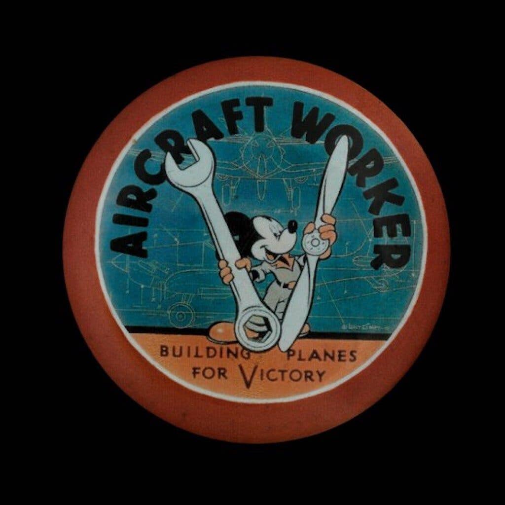 <em>Aircraft worker victory button worn by a worker at the Lockheed Martin munitions factory in Burbank, California (just over the hill from the Disney Studio), where thousands of aircraft were manufactured during the war. (Division of Political History)</em>