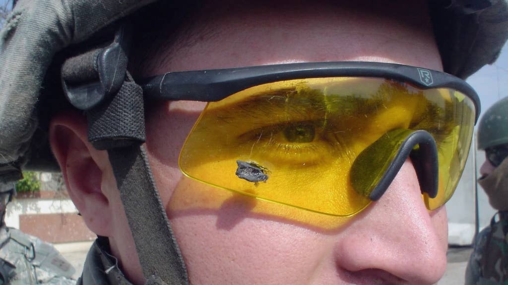 1st Lt. Anthony Aguilar wears the ballistic protective eyewear that prevented a bomb-fragment from possibly damaging his eyes when an IED detonated near his Stryker vehicle while on patrol in Mosul. (Photo by Company C, Task Force 2-1, Feb. 2006.)