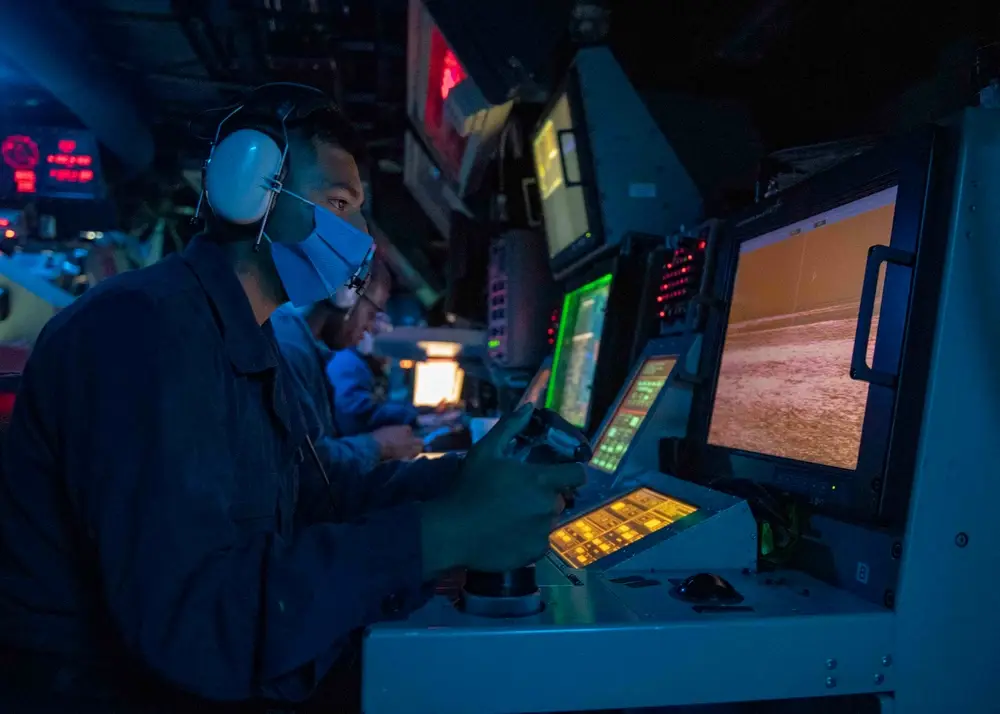 Taiwan Strait (August 18, 2020) Gunner’s Mate Seaman Daniel Campos, from Chico, Texas, stands optical sighting system watch in the combat information center as the Arleigh Burke-class guided-missile destroyer USS Mustin (DDG 89) conducts routine operations. Mustin is forward-deployed to the U.S. 7th Fleet area of operations in support of security and stability in the Indo-Pacific region. (U.S. Navy photo by Mass Communication Specialist 3rd Class Cody Beam)