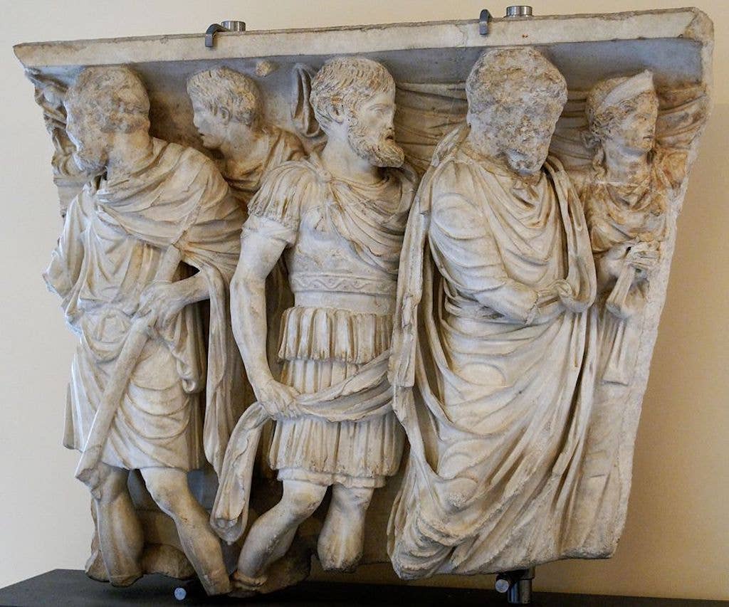 Fragment of a relief from a sarcophagus depicting stages of the deceased's life: religious initiation, military service, and wedding (mid-2nd century AD).