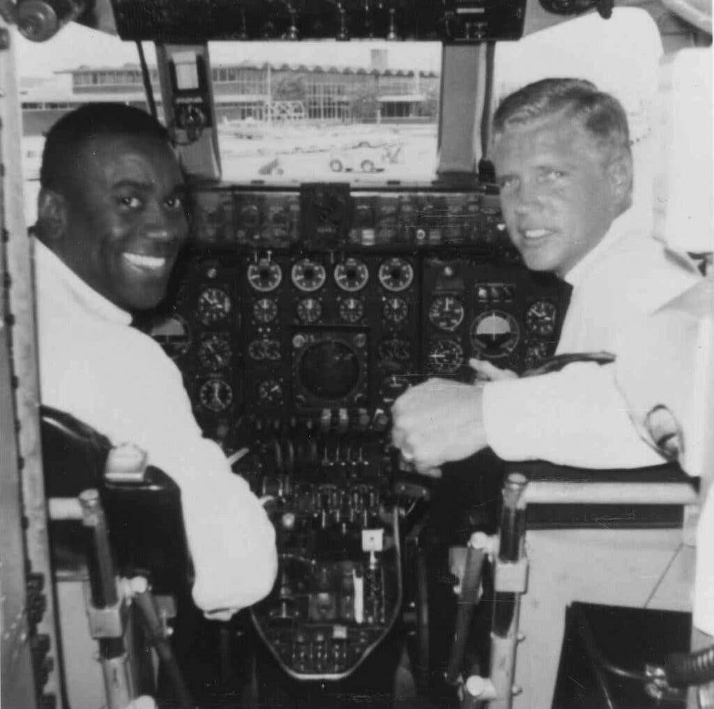 Black pilot in cockpit of commercial airliner