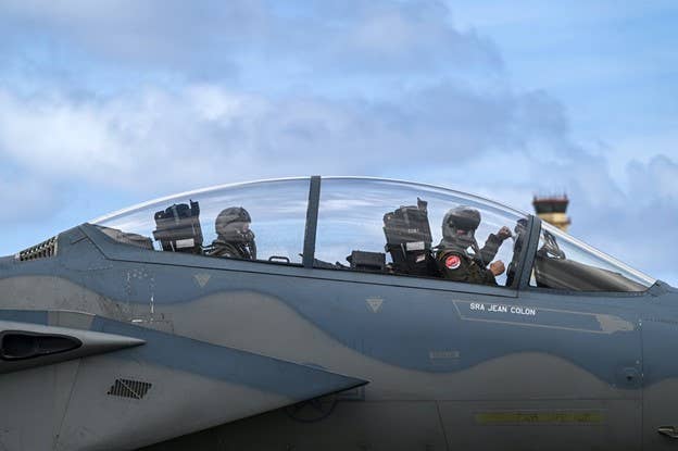 ANDERSEN AIR FORCE BASE, GUAM, 02.07.2022<br>Photo by Tech. Sgt. Matthew Lotz, Pacific Air Forces Public Affairs<br>U.S. Air Force Staff Sgt. Roslyn Ward (Left), 1st Combat Camera Squadron aerial combat videographer, and an F-15C Eagle pilot assigned to the 67th Fighter Squadron, Kadena Air Base, Japan, prepare for a flight during exercise Cope North 22 at Andersen Air Force Base, Guam, Feb. 7, 2022. More than 2,500 U.S. Airmen, Marines, and Sailors will train alongside 1,000 combined JASDF and RAAF counterparts in CN22. Approximately 130 aircraft from over 30 units will fly in the exercise.