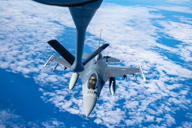 PACIFIC OCEAN, 02.08.2022<br>Photo by Master Sgt. Joey Swafford, 1st Combat Camera Squadron<br>A U.S. Air Force F-16 Fighting Falcon pilot assigned to the 14th Fighter Squadron conducts aerial refueling with a KC-135 Stratotanker aircraft assigned to the 909th Air Refueling Squadron during exercise Cope North 22 over the Pacific Ocean, Feb. 8, 2022. CN 22 allows each nation to hone vital readiness skills and enhance interoperability among multiple mission areas to include air superiority, interdiction, electronic warfare, tactical airlift, and aerial refueling capabilities.