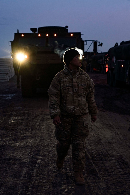 ZAMOSC, POLAND, 02.22.2022<br>Photo by Sgt. Claudia Nix, 82nd Airborne Division<br>A Paratrooper assigned to the 3rd Brigade Combat Team, 82nd Airborne Division directs an M1075 Palletized Load System vehicle at an assembly area in Zamość, Poland, Feb. 22, 2022. The 82nd Airborne Division is deployed in support of U.S. European Command to assure our Allies and partners in the region and deter any future aggression.