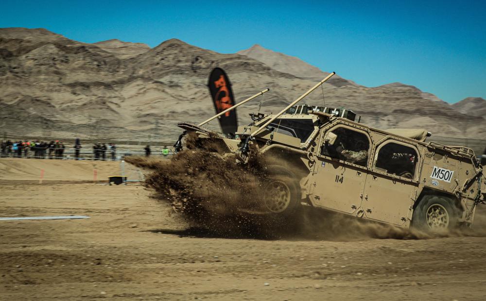 <em>One of the GMV 1.1s lands after catching air on the first lap of the Mint 400 (U.S. Army)</em>