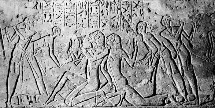 A carved relief from the Kadesh inscriptions showing Shasu spies being beaten by Egyptians.