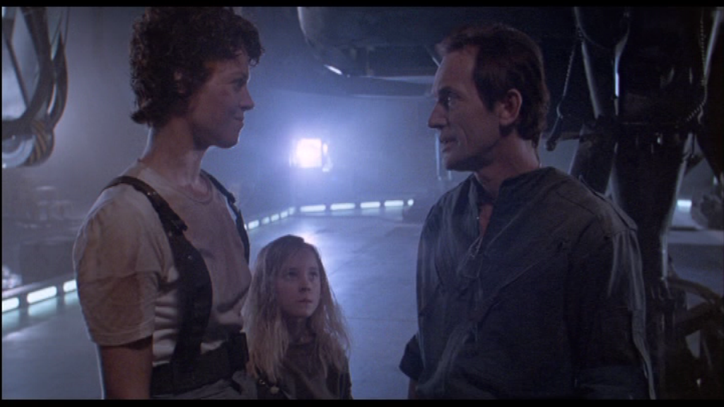 Henriksen (left) as Bishop on-screen with Sigourney Weaver (right) as Ripley and Carrie Henn (center) as Newt in <em>Aliens</em>. Photo courtesy of robf.com.au.