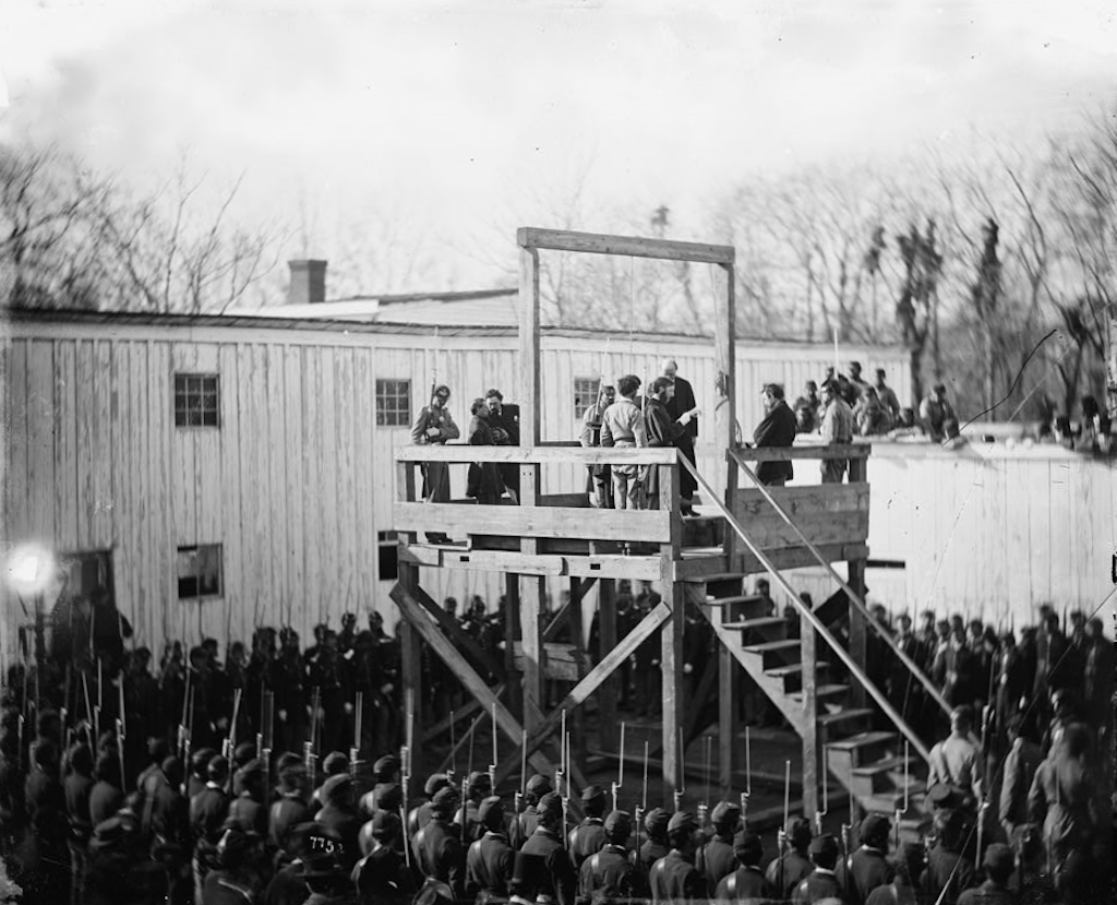 The execution of Henry Wirz, commandant of the (Confederate) Andersonville Prison, near the US Capitol moments after the trap door was sprung.