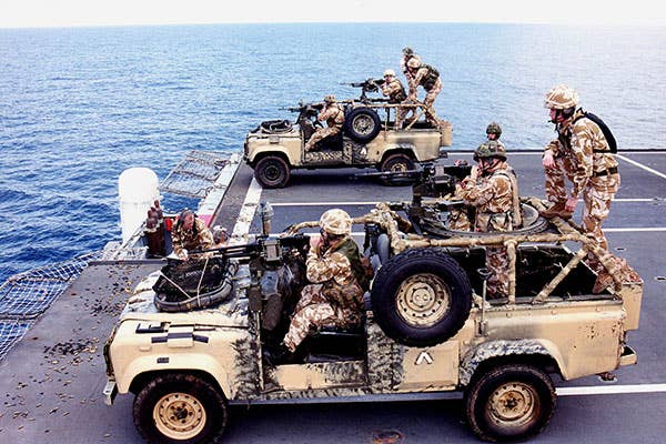 <em>Royal Marines conduct gunnery from their Land Rovers aboard HMS </em>Ocean<em> (MOD)</em>