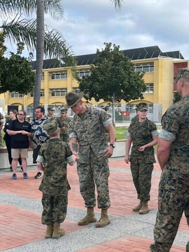 <em>"In this photo, I'm congratulating Wyatt with a SgtMaj coin, telling him how proud we are of his spirit, determination, and being a role model to everyone, and no matter what life throws at you, use today as a reminder anything is possible." (Matthew Dorsey/LinkedIn)</em>