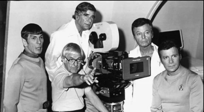 Leonard Nimoy, Robert Wise (seated), Gene Roddenberry (standing), DeForest Kelly and William Shatner filming <em>Star Trek: The Motion Picture</em>. Photo courtesy of startrek.com.