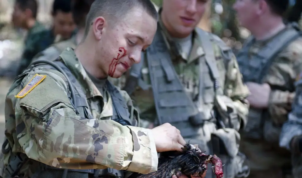 U.S. Army Pvt. Izzak Piscitel, 1st Battalion, 23rd Infantry, 1st Stryker Brigade Combat Team, 2nd Infantry Division quickly prepares to cook a chicken during the jungle survival course with the Royal Thai Army 2nd Battalion, 3rd Infantry in Korat, Thailand, Feb. 20, 2017. Exercise Cobra Gold is the largest Theater Security Cooperation exercise in the Indo-Asia-Pacific region and is an integral part of the U.S. commitment to strengthen engagement in the region. (U.S. Army photo by Major Kelly S Haux)