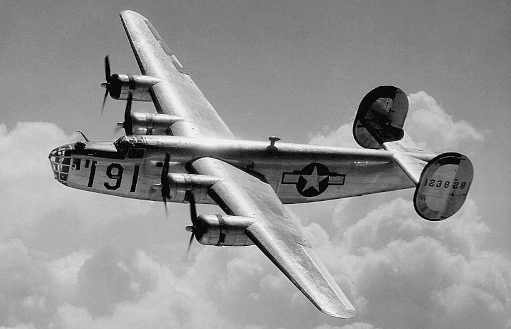 A Consolidated B-24 Liberator from Maxwell Field, Alabama, four engine pilot school, glistens in the sun as it makes a turn at high altitude in the clouds. Heavy Bombers. (U.S. Air Force photo)
