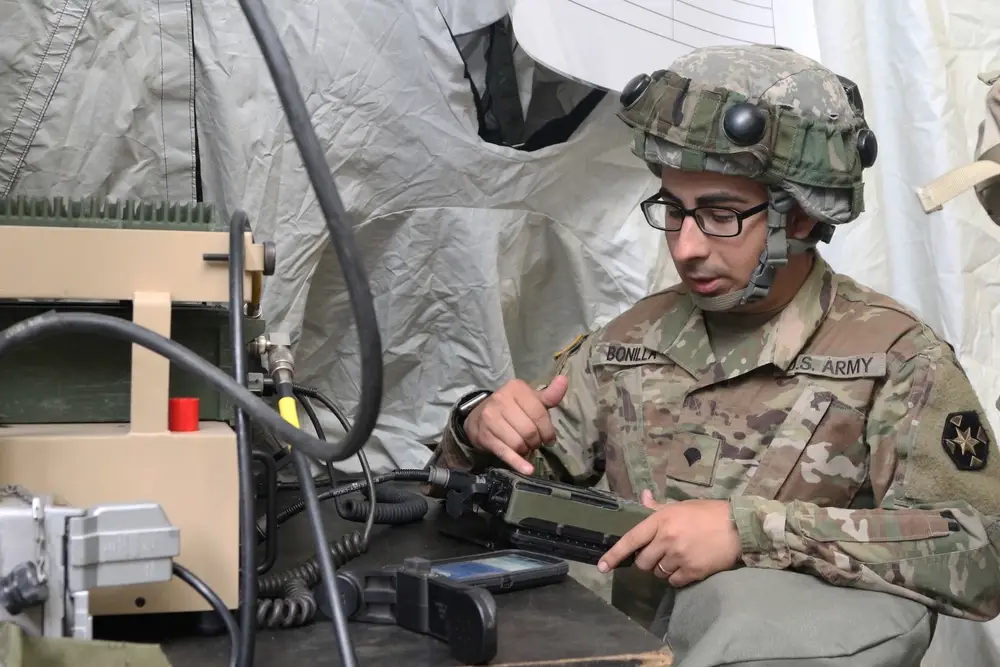 U.S. Army Spc. Alex R. Bonilla of Somerville, Mass., a signal support specialist for the 399th Field Hospital, sets up a radio for the unit’s base as part of the Combat Support Tactical Exercise at Fort McCoy, Wis., Aug. 12, 2019. Units, including Navy, Marines and Air Force personnel, had to maintain communications throughout the exercise. (U.S. Army photo by Sgt. 1st Class Gary A. Witte, 207th Regional Support Group)