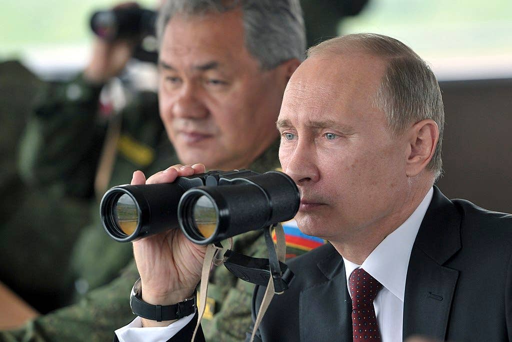 Putin with Russia's long-serving minister of defense, Army General Sergey Shoygu, in the Eastern Military District, 2013.