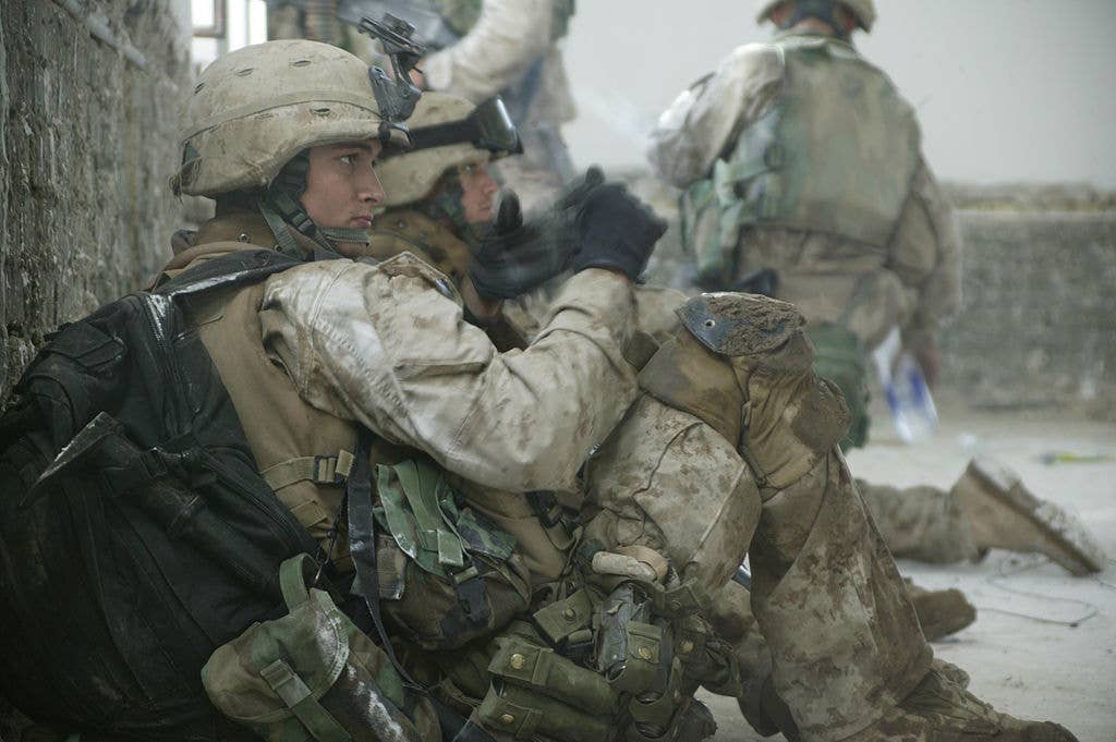 U.S. Marines take a break while searching the city of Fallujah in November 2004.