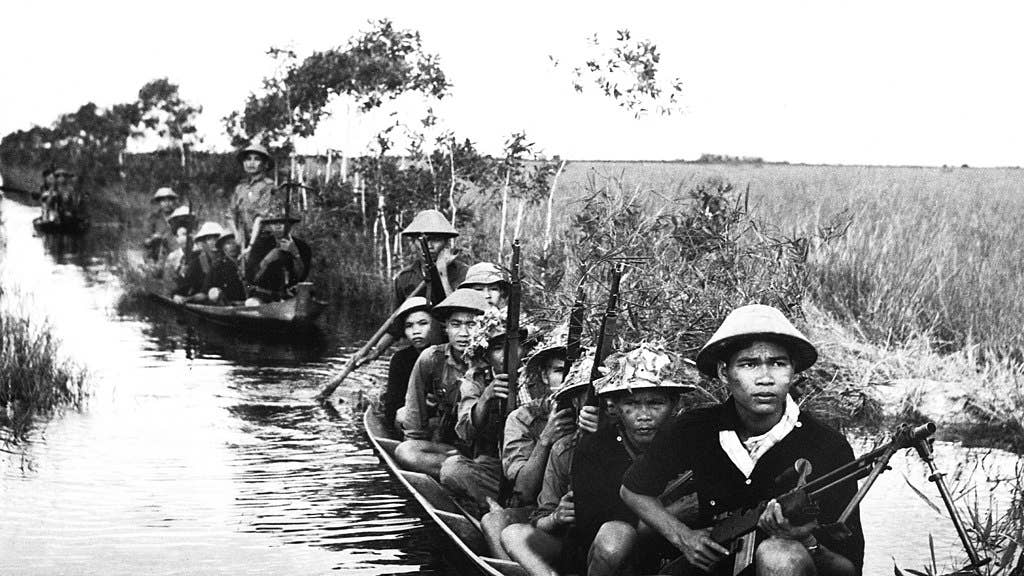 Captured communist photo shows VC crossing a river in 1966. (Public domain)