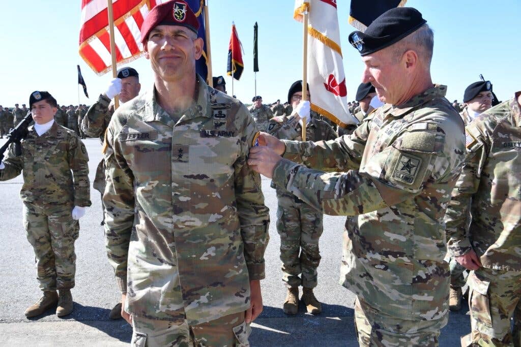 <em>Gen. McConville places the 11th Airborne shoulder patch on Maj. Gen. Eifler's shoulder during the unit activation ceremony (U.S. Army Chief of Staff)</em>