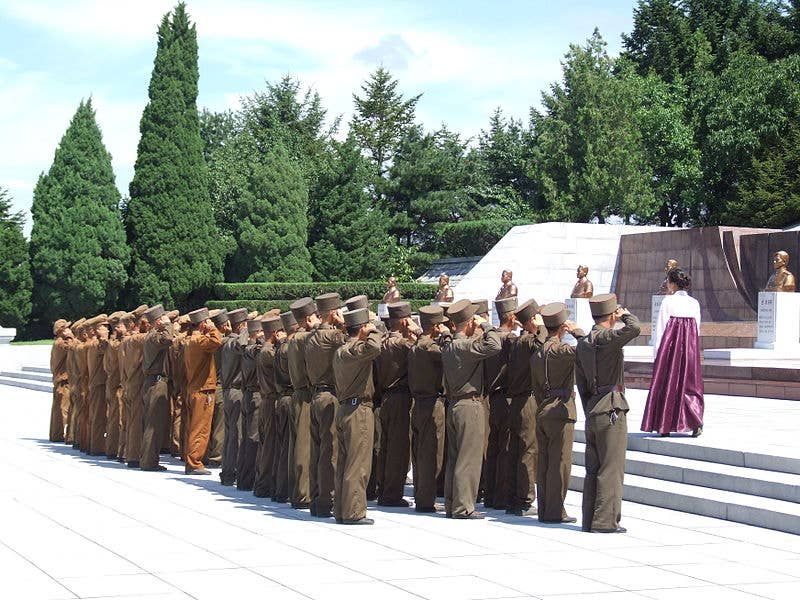 North Korean soldiers saluting at the <a href="https://en.wikipedia.org/wiki/Revolutionary_Martyrs%27_Cemetery">Revolutionary Martyrs' Cemetery</a> in Pyongyang, 2012.