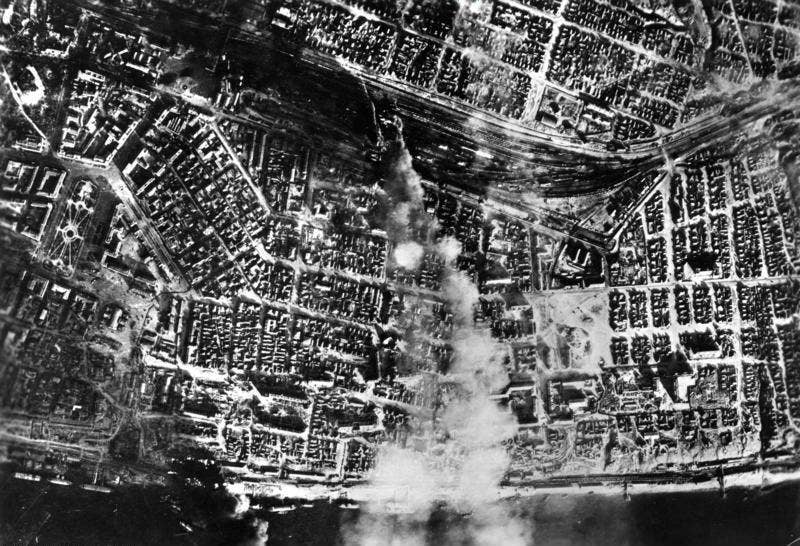 Smoke over the city center after aerial bombing by the German <a href="https://en.wikipedia.org/wiki/Luftwaffe">Luftwaffe</a> on the central station.