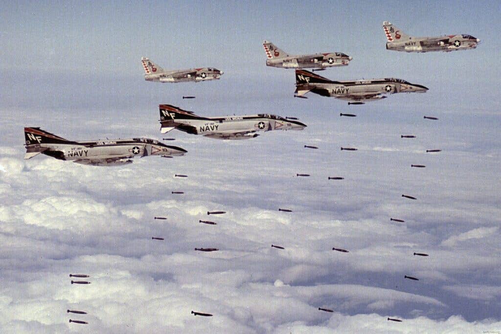 <em>F-4s from VF-161 and A-7s from VA-85 conduct a strike over Vietnam in March 1973 (U.S. Navy)</em>