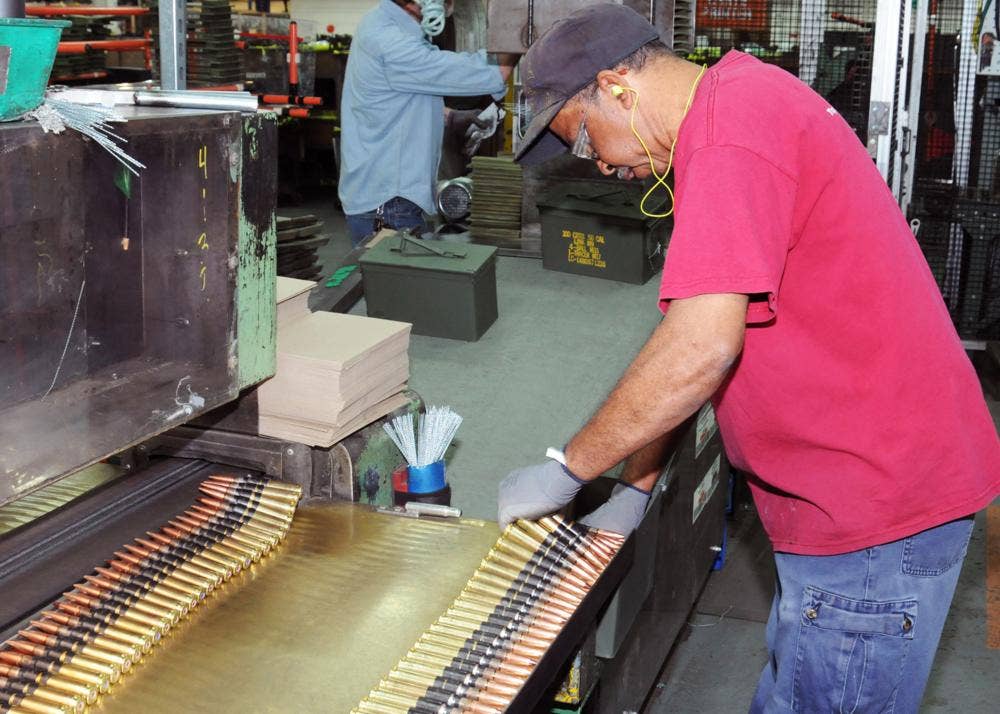 <em>A worker inspects .50 caliber ammo at Lake City Army Ammunition Plant (U.S. Army)</em>
