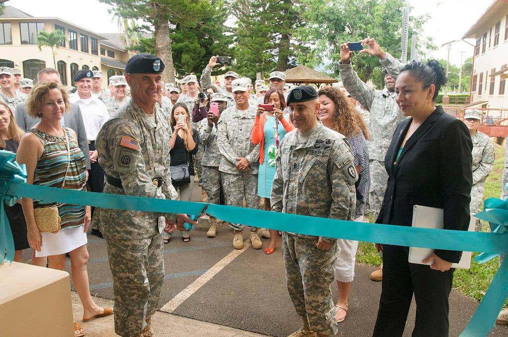 25th Infantry Division Commanding General Maj. Gen. Charles Flynn cuts the ceremonial ribbon during the opening of the SHARP Resource Center on Schofield Barracks Oct. 17. The center will provide SHARP victim advocacy, investigative, legal services for the Army community. (DVIDS)