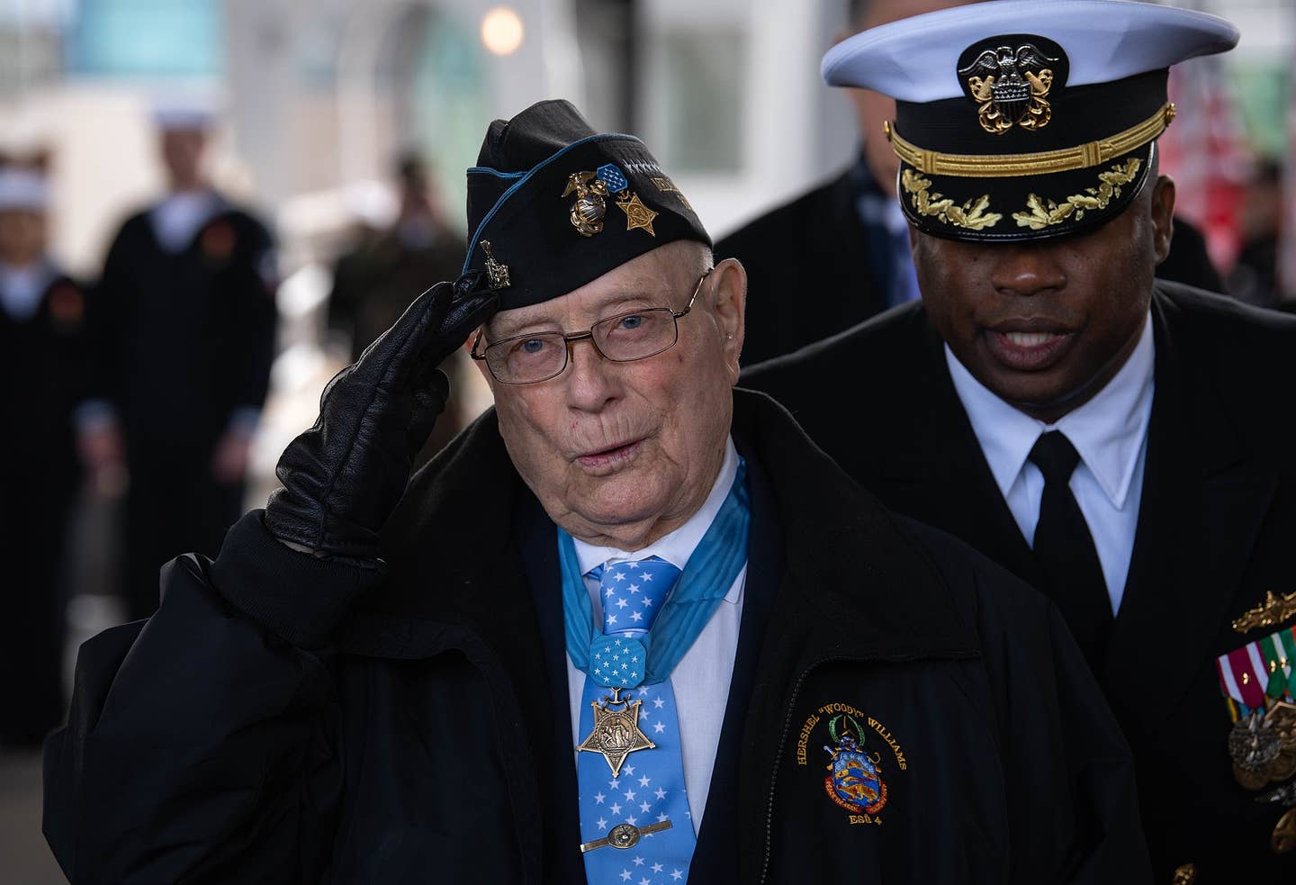 Hershel Woodrow Williams, Retired Chief Warrant Officer Four and Medal of Honor recipient, salutes as he is introduced to the stage along with other members of the ship commissioning committee, March 7, 2020 in Norfolk, VA...The ship commissioning ceremony continues a tradition three centuries old, observed by navies around the world and by our own Navy since December 1775, when “Alfred”, the first ship of the Continental Navy, was commissioned at Philadelphia. (U.S. Marine Corps Photo by Lance Cpl. Fernando Moreno)