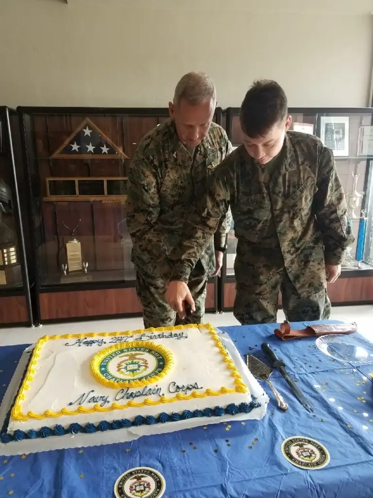 Capt. Michael Brown, left, 3rd Marine Aircraft Wing chaplain, and a Sailor, who is the youngest chaplain’s assistant, cut the ceremonial cake honoring the Chaplain Corps’ 242nd birthday at Marine Corps Air Station Miramar, California, Nov. 28, 2017. The Chaplain Corps was established Nov. 28, 1775, making it the oldest corps in the Navy. (U.S. Marine Corps courtesy photo)