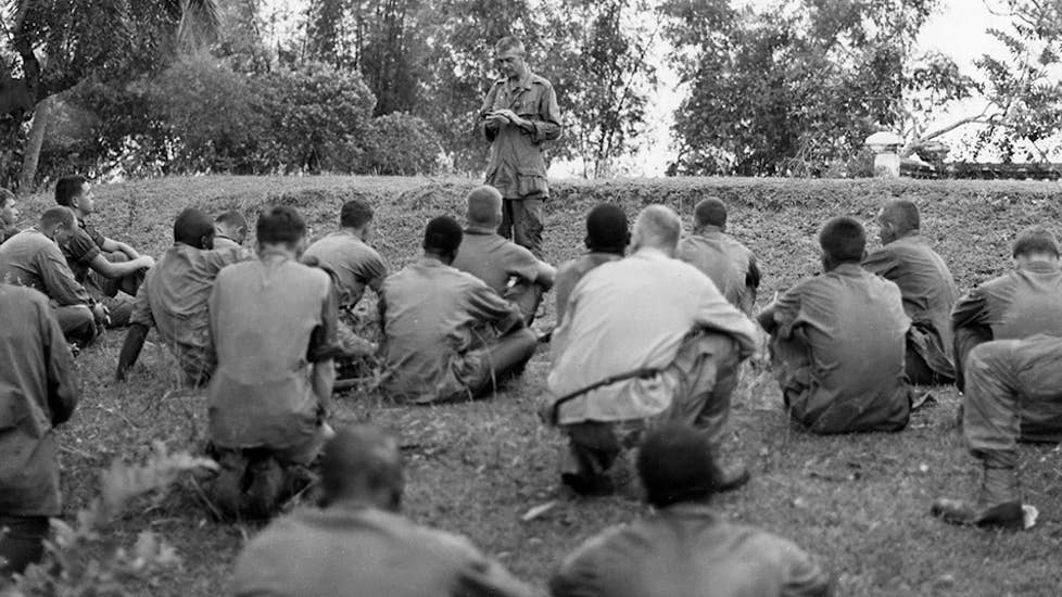 Navy Lt. Vincent Capodanno conducts a field prayer service for the men of A Company, 1st Battalion, 7th Marines. Photo courtesy of the Father Capodanna Guild, 1967. (Photo by Katie Lange)