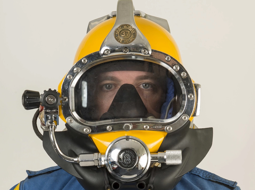 Chief Navy Diver Joshua Baker, assigned to Explosive Ordnance Disposal Group (EODGRU) 2, poses for a portrait while wearing a KM-37 dive helmet. EODGRU 2, headquartered at Joint Expeditionary Base Little Creek-Fort Story, oversees all East Coast-based Navy EOD mobile units, including one forward deployed mobile unit in Spain, as well as EOD Expeditionary Support Unit (EODESU) 2, EOD Training and Evaluation Unit (EODTEU) 2, and the only East Coast-based mobile diving and salvage unit, MDSU 2. (U.S. Navy photo by Mass Communication Specialist 2nd Class Charles Oki/Released)