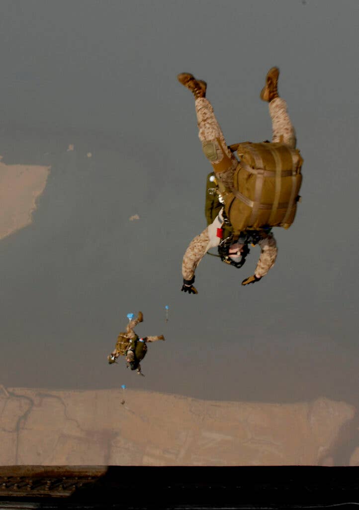 Members of the 13th Marine Expeditionary Unit (MEU) jump from an H-53 Sea Stallion helicopter, from the "Evil Eyes" of Marine Medium Helicopter Squadron (HMM) 163, during a routine skydiving evolution. The evolution was conducted to update qualifications on high altitude jumps using oxygen masks and carrying combat equipment. The 13th MEU is embarked aboard amphibious assault ship USS Boxer (LHD 4) and is underway supporting maritime security operations and theater security cooperation efforts in the U.S. 5th Fleet area of responsibility. (U.S. Navy photo by Mass Communication Specialist 3rd Class Anna Kiner/Released)